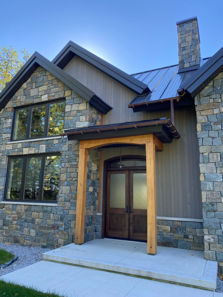 Large rustic gray three-story wood gable roof idea with a metal roof and a brown roof