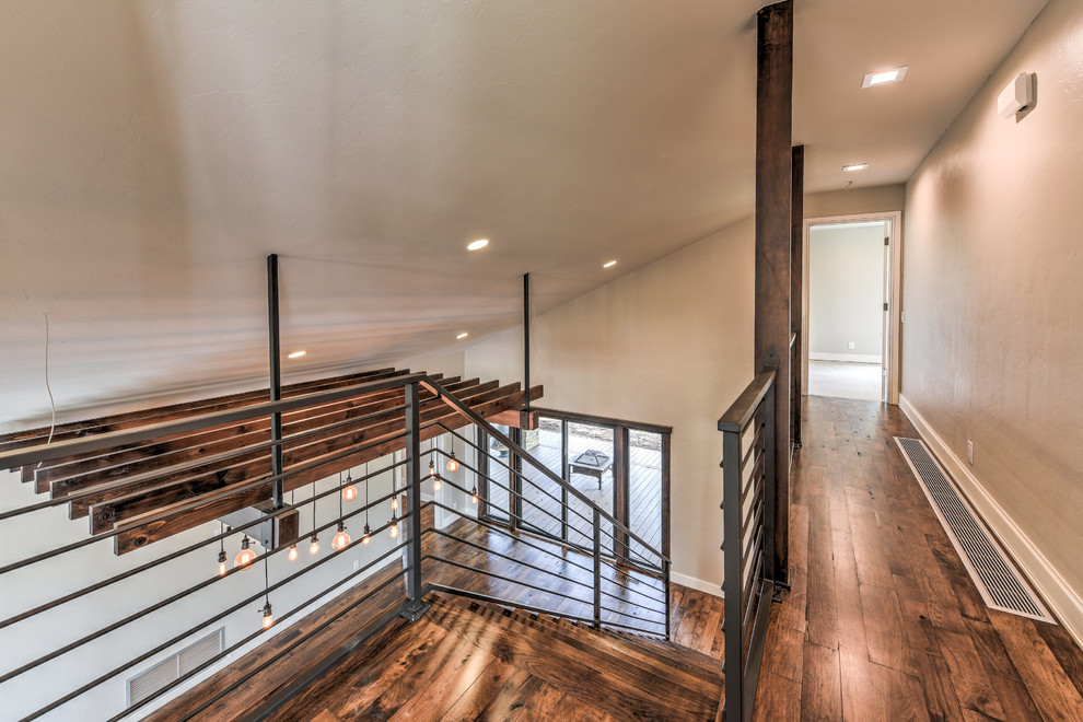 Mid-sized country wood straight staircase in Oklahoma City with wood risers and metal railing.