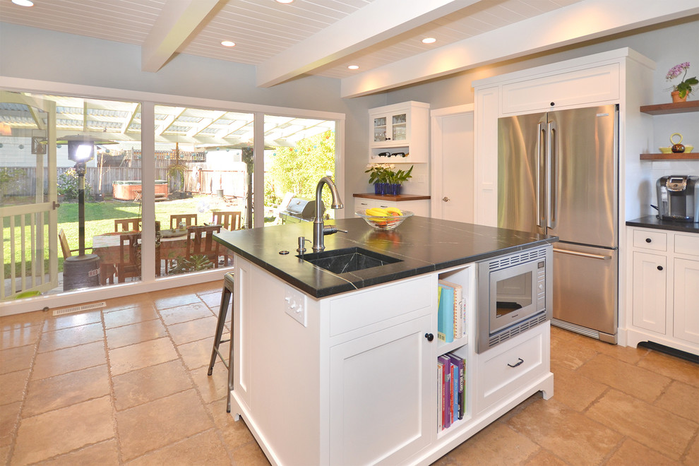 This is an example of a mid-sized midcentury u-shaped kitchen in San Francisco with a single-bowl sink, shaker cabinets, white cabinets, marble benchtops, white splashback, ceramic splashback, stainless steel appliances, terra-cotta floors and with island.