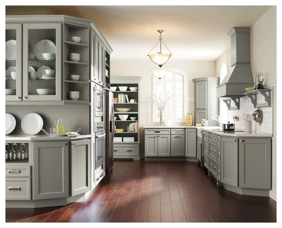 Example of a large transitional l-shaped dark wood floor enclosed kitchen design in Toronto with a farmhouse sink, shaker cabinets, gray cabinets, quartz countertops, white backsplash, ceramic backsplash and stainless steel appliances
