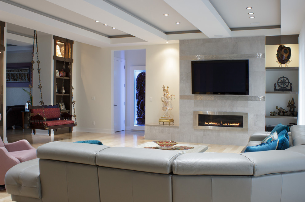 Photo of a large asian open concept living room in New York with beige walls, light hardwood floors, a ribbon fireplace and a tile fireplace surround.
