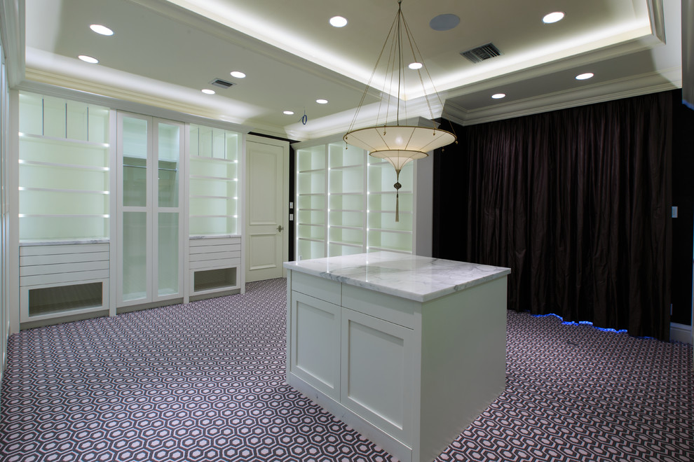 Design ideas for an expansive transitional women's walk-in wardrobe in Miami with glass-front cabinets, white cabinets and carpet.