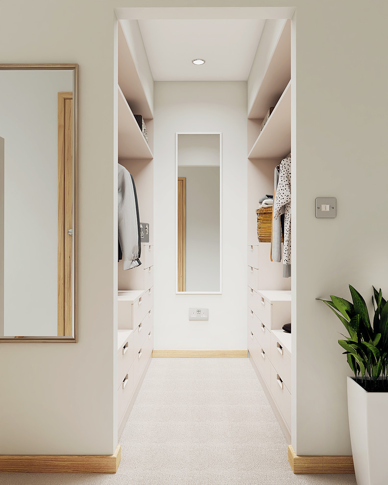 Inspiration for a small contemporary gender-neutral dressing room in Cambridgeshire with flat-panel cabinets, white cabinets and carpet.