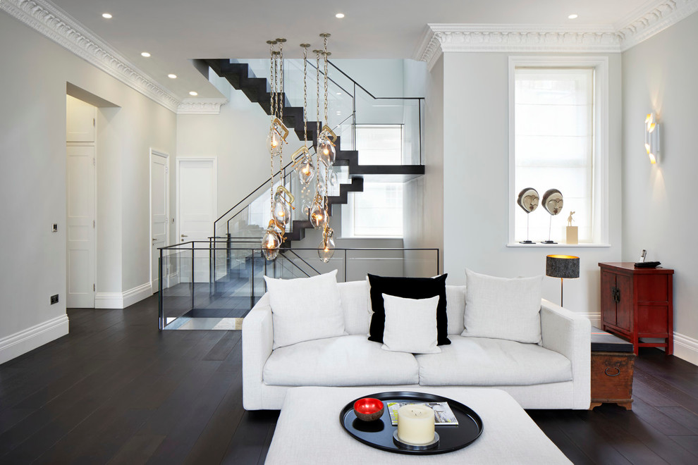 Inspiration for a contemporary living room in London with white walls and dark hardwood floors.
