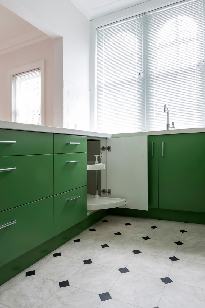 Photo of a small contemporary u-shaped separate kitchen in Sydney with a drop-in sink, flat-panel cabinets, green cabinets, quartz benchtops, white splashback, subway tile splashback, stainless steel appliances, vinyl floors, no island, grey floor and white benchtop.