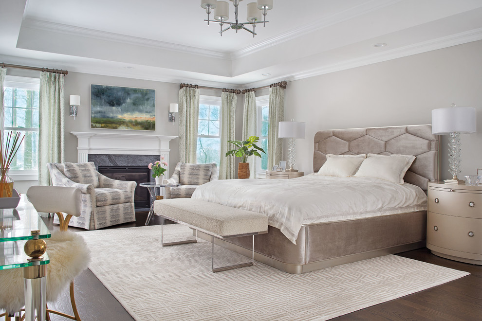Design ideas for a transitional master bedroom in New York with grey walls, dark hardwood floors, a standard fireplace, a stone fireplace surround and brown floor.