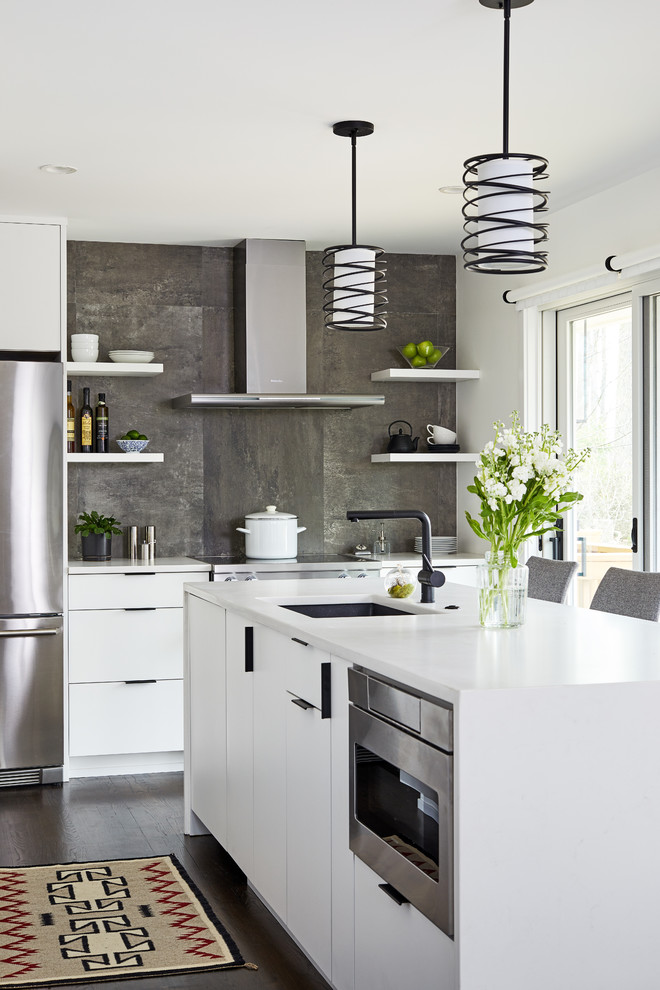 Design ideas for a small contemporary l-shaped separate kitchen in DC Metro with an undermount sink, flat-panel cabinets, white cabinets, quartz benchtops, grey splashback, porcelain splashback, stainless steel appliances, dark hardwood floors, with island and white benchtop.