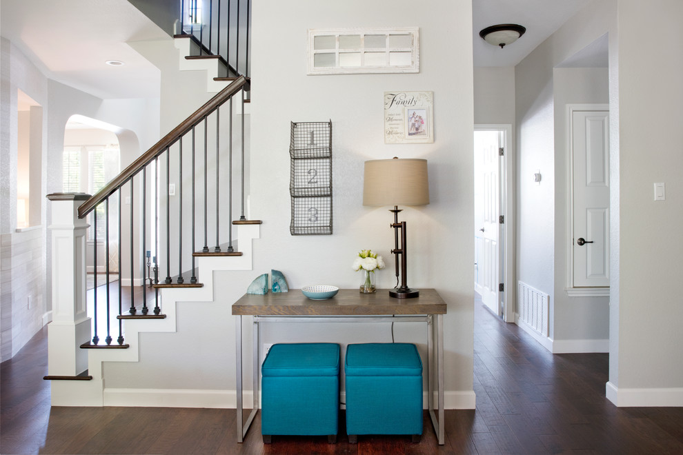 Design ideas for a transitional entryway in Austin with grey walls and dark hardwood floors.