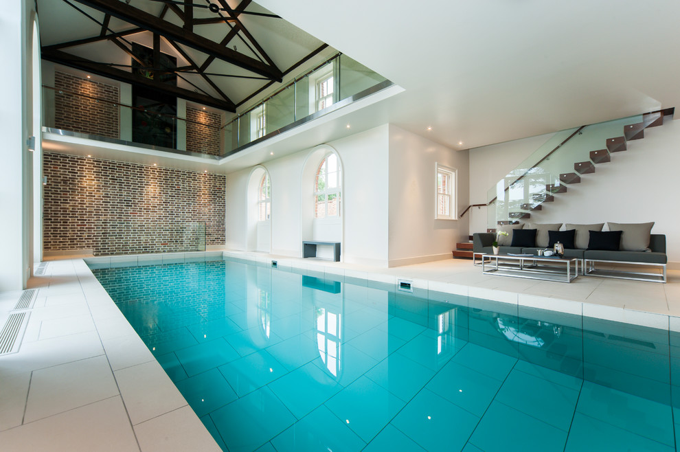 Photo of a contemporary indoor rectangular pool in Cambridgeshire with a pool house.