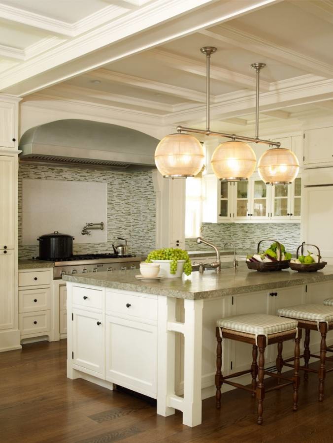 Photo of a large beach style eat-in kitchen in New York with an undermount sink, shaker cabinets, white cabinets, green splashback, ceramic splashback and panelled appliances.