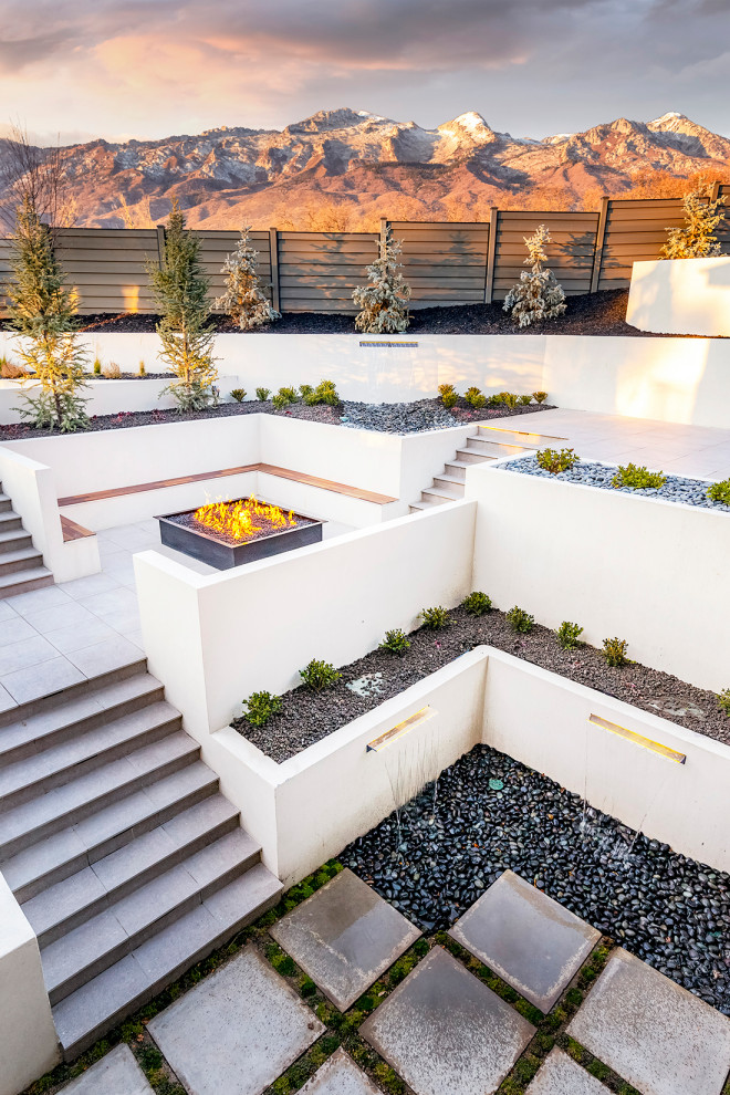 Inspiration for a modern backyard garden in Salt Lake City with a retaining wall and concrete pavers.