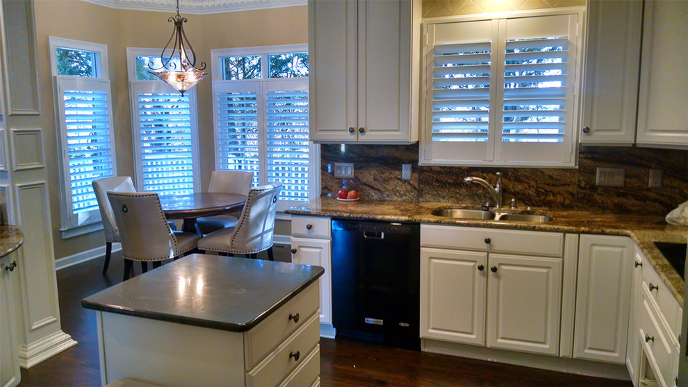 Inspiration for a large transitional u-shaped medium tone wood floor and brown floor eat-in kitchen remodel with a double-bowl sink, raised-panel cabinets, white cabinets, brown backsplash, stone slab backsplash, black appliances and an island
