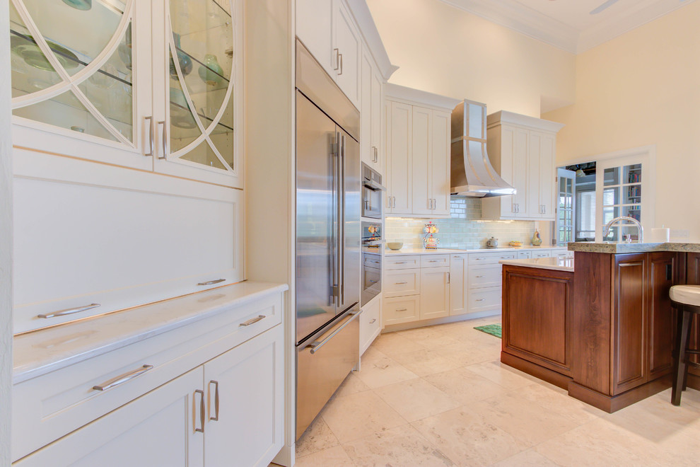 Inspiration for a large transitional single-wall enclosed kitchen remodel with an undermount sink, flat-panel cabinets, white cabinets, quartz countertops, blue backsplash, stone tile backsplash, stainless steel appliances and an island