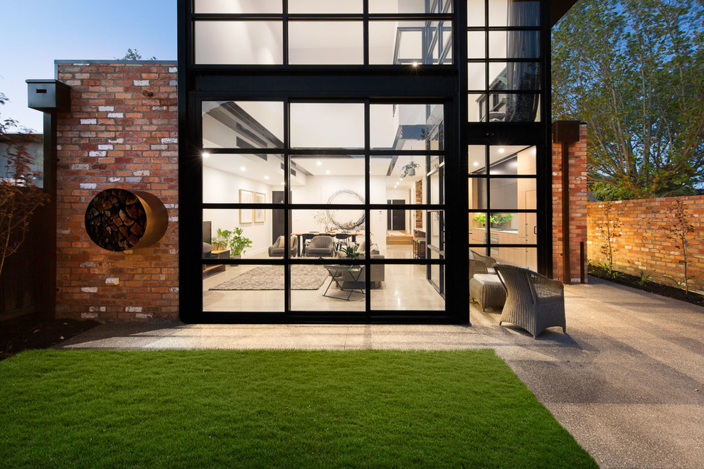 This is an example of a mid-sized contemporary two-storey brick brown exterior in Melbourne with a gable roof.