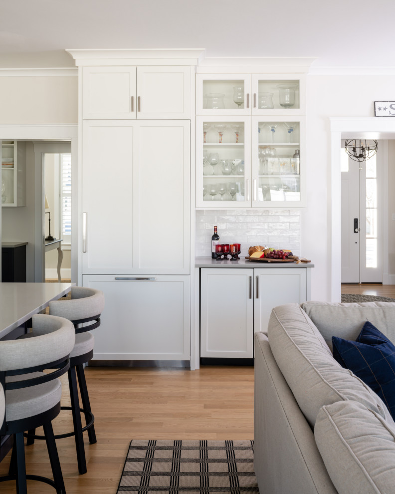Example of a transitional kitchen design in Providence with an undermount sink, shaker cabinets, quartzite countertops, subway tile backsplash and an island