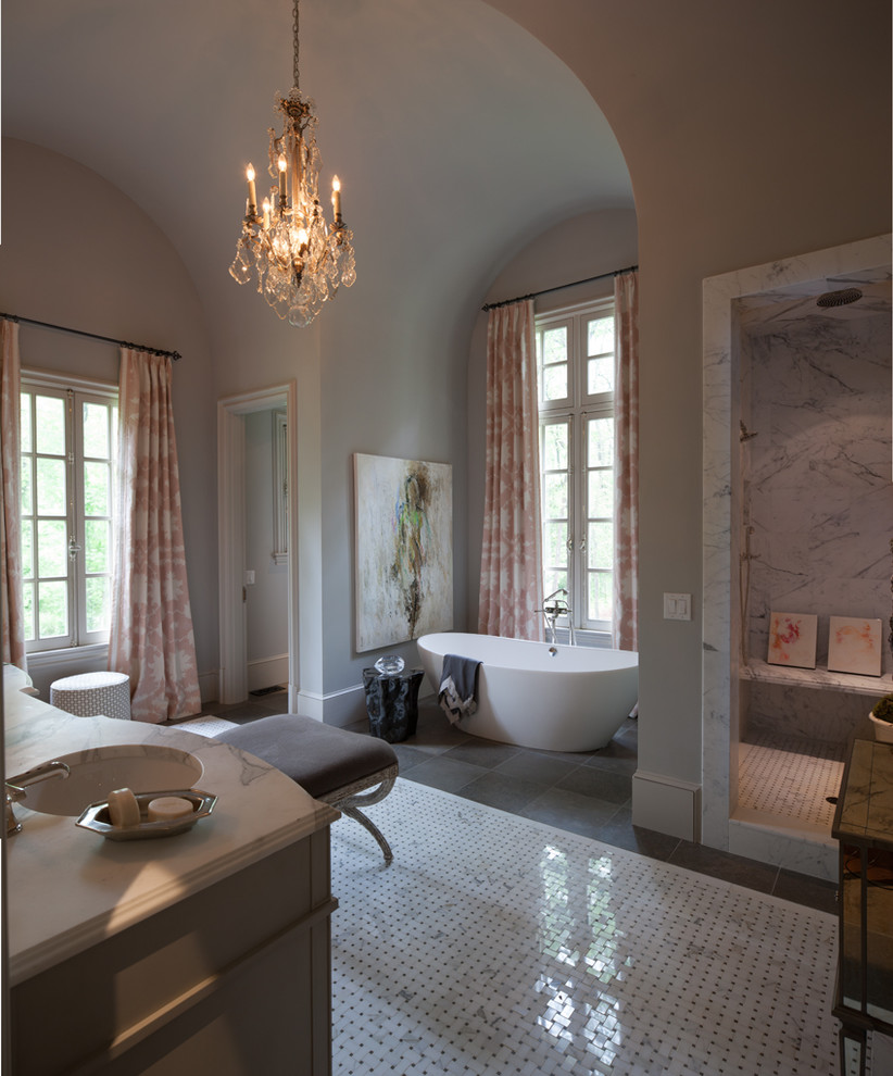 Large traditional master bathroom in Atlanta with furniture-like cabinets, grey cabinets, marble benchtops, white tile, mosaic tile, a freestanding tub, an alcove shower, a one-piece toilet, an undermount sink, grey walls and mosaic tile floors.