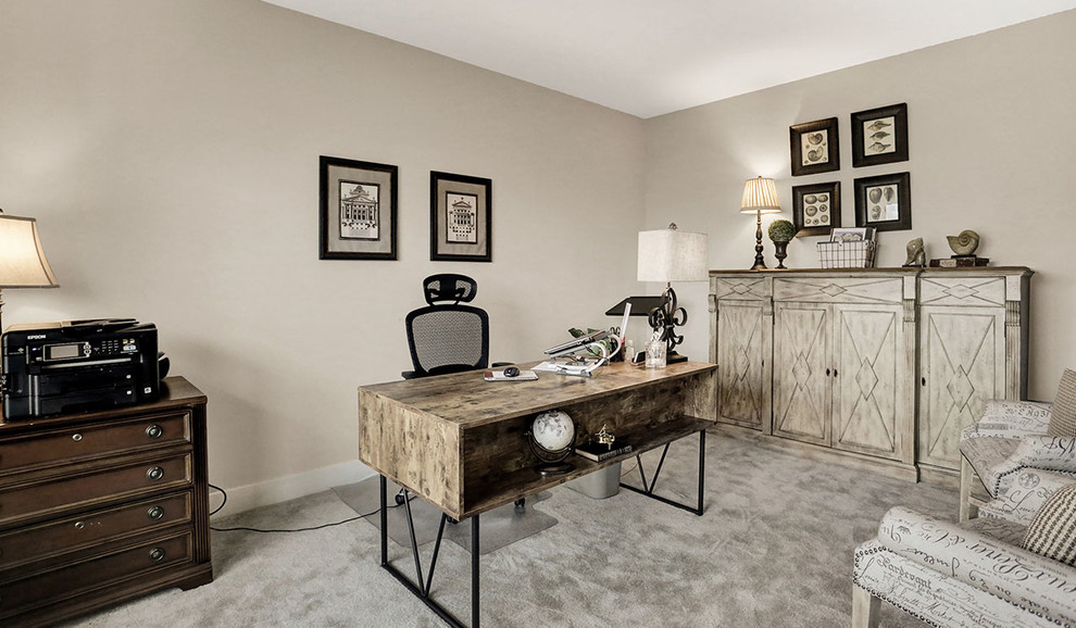 Mid-sized traditional home office in Other with beige walls, carpet and beige floor.