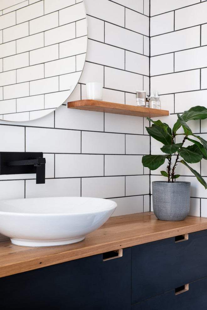 Design ideas for a large modern bathroom in Geelong with black cabinets, white tile, ceramic tile, wood benchtops, brown benchtops, a single vanity and a built-in vanity.