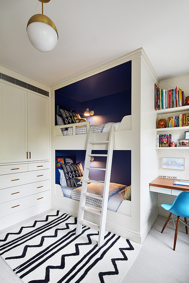 Mid-sized transitional gender-neutral kids' bedroom in New York with blue walls and carpet for kids 4-10 years old.
