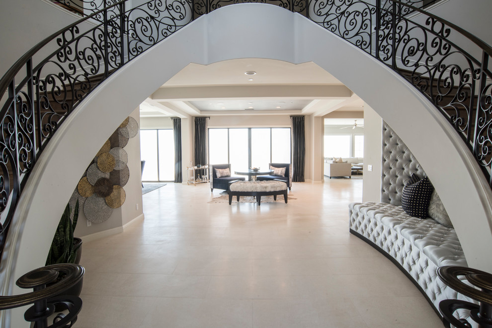 Photo of a mid-sized contemporary foyer in Orange County with grey walls, limestone floors and white floor.