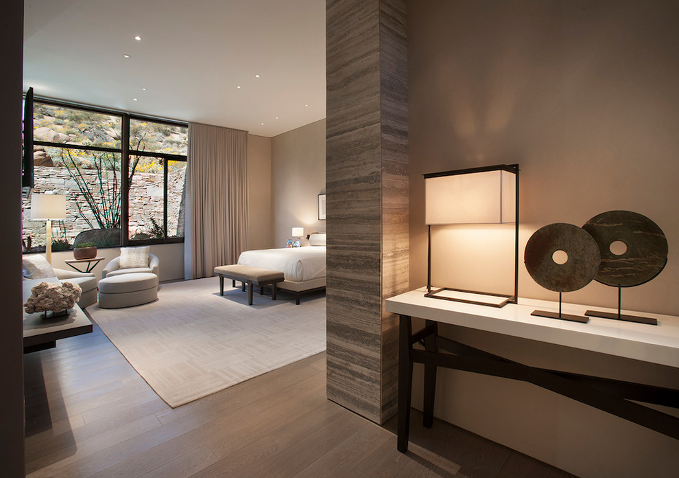 Expansive modern master bedroom in Phoenix with medium hardwood floors and grey walls.