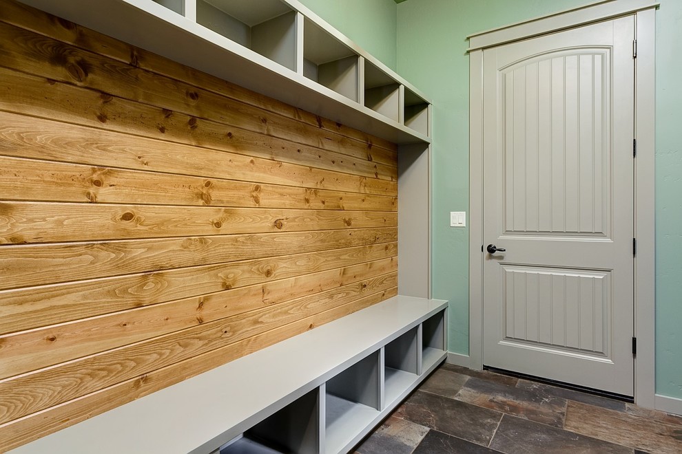 Inspiration for a large arts and crafts mudroom in Boise with green walls, slate floors, a single front door and a gray front door.