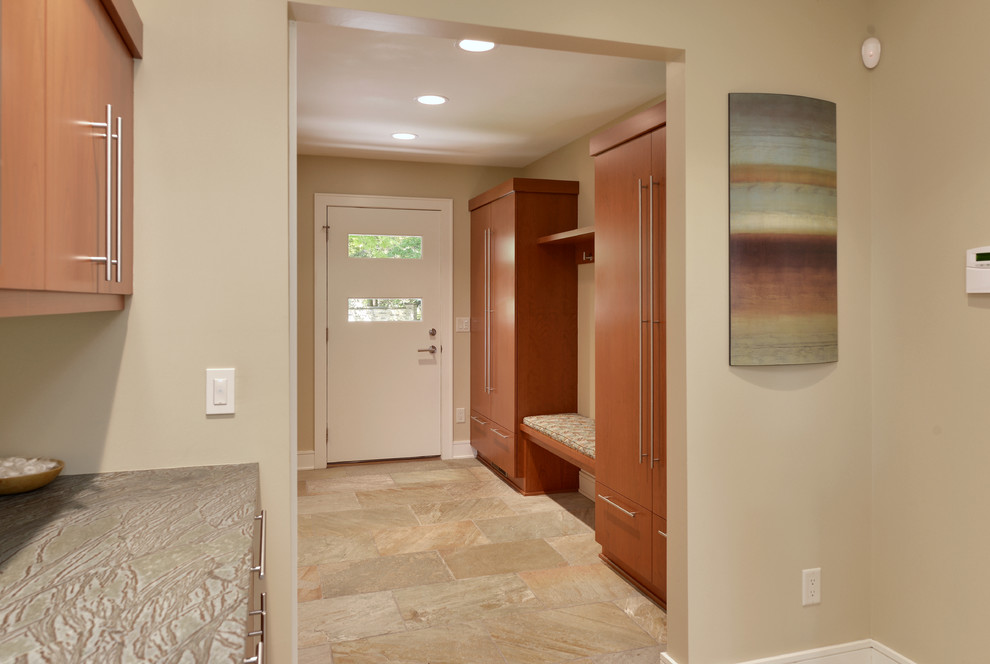 Design ideas for a large contemporary mudroom in Milwaukee with beige walls, ceramic floors, a pivot front door, a white front door and multi-coloured floor.