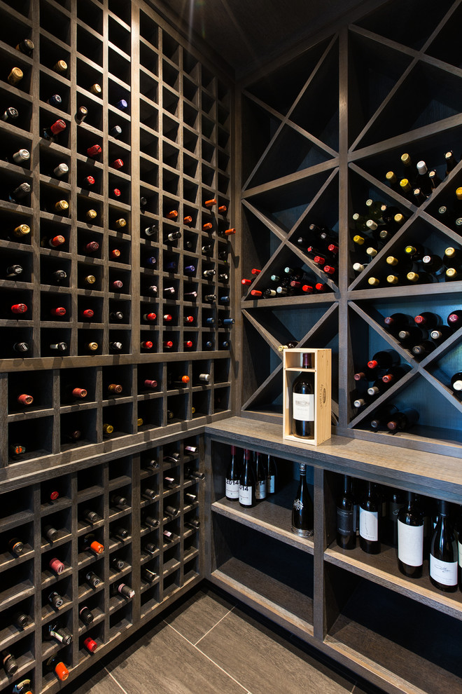 Contemporary wine cellar in New York with diamond bins and brown floor.