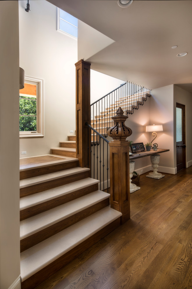 Mid-sized country limestone l-shaped staircase in Dallas with wood risers.