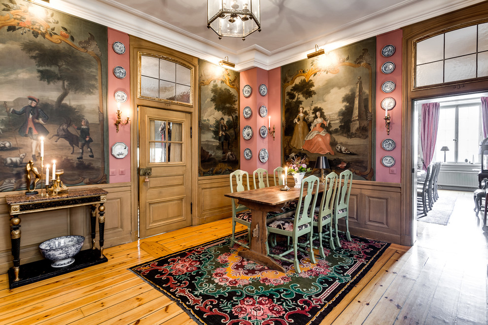 Inspiration for a traditional dining room in Stockholm with pink walls, medium hardwood floors and orange floor.