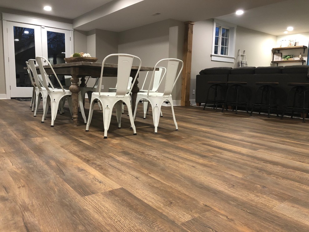Photo of a country dining room in Cincinnati with vinyl floors and brown floor.