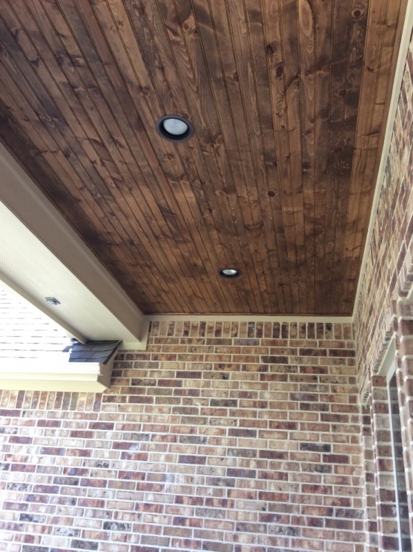 Example of a mid-sized mountain style backyard deck design in Austin with a roof extension