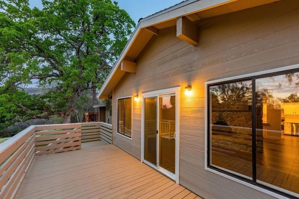 Deck - mid-sized rustic two-story and backyard wood brown deck idea with a shingle roof and no cover