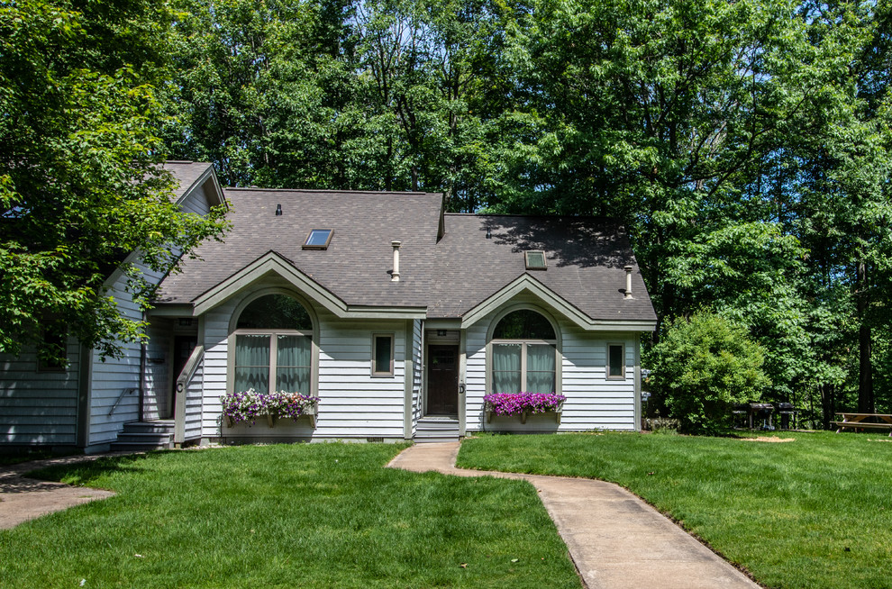 Mid-sized transitional gray two-story vinyl townhouse exterior idea with a shingle roof