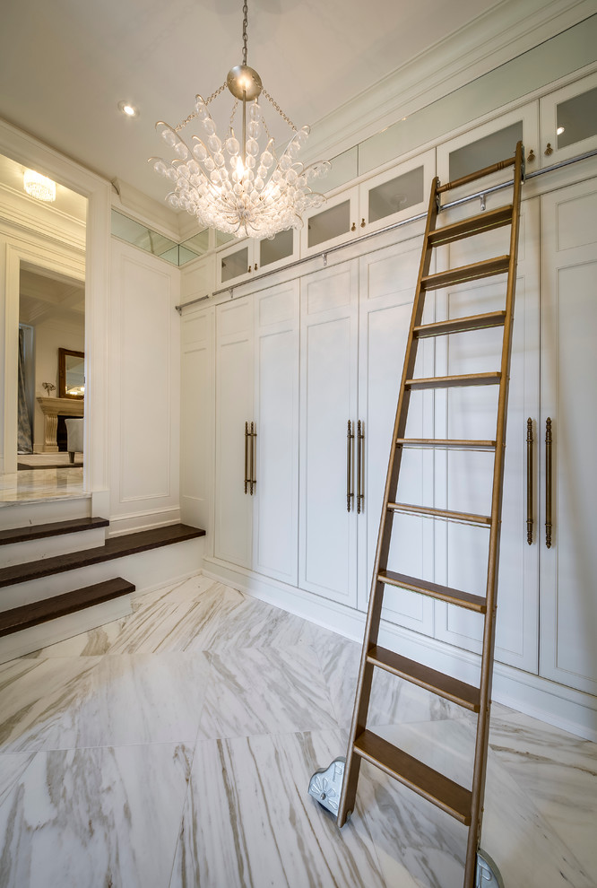 Inspiration for a mid-sized modern mudroom in Toronto with white walls and marble floors.