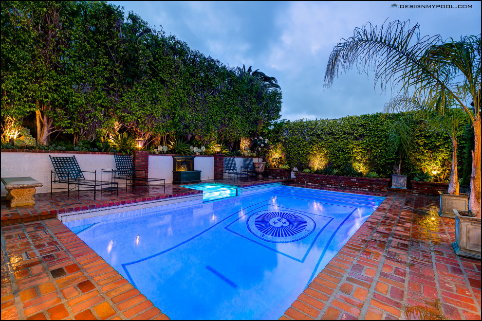 This is an example of a medium sized midcentury back rectangular above ground swimming pool in Los Angeles with brick paving.