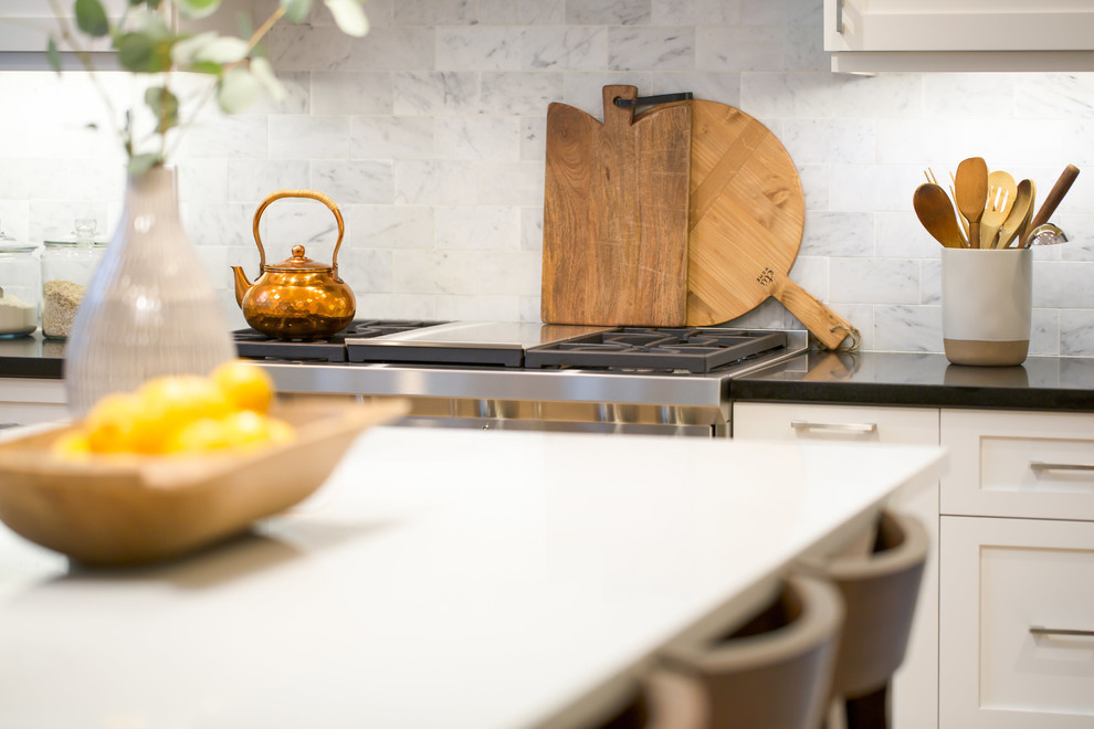 Inspiration for a mid-sized transitional l-shaped light wood floor and brown floor eat-in kitchen remodel in Seattle with an undermount sink, shaker cabinets, white cabinets, quartz countertops, multicolored backsplash, marble backsplash, stainless steel appliances and an island