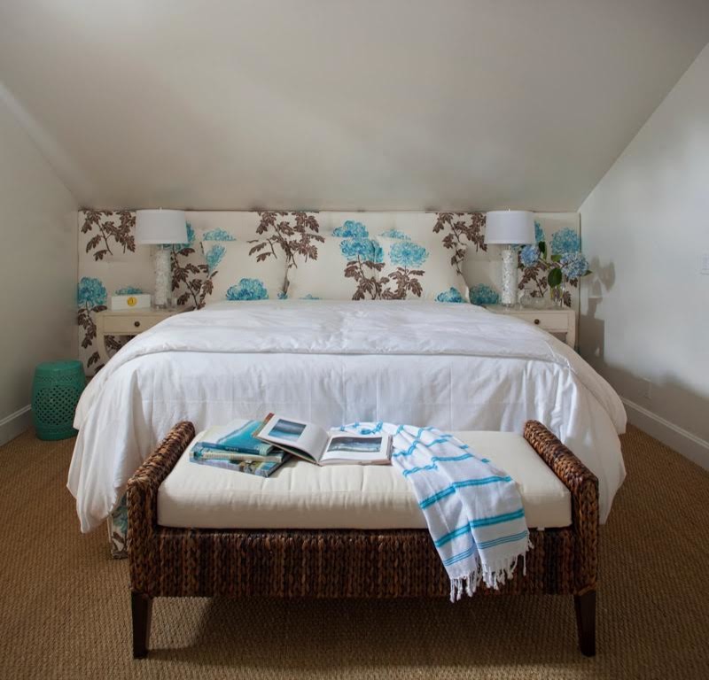 This is an example of a mid-sized beach style guest bedroom in Jacksonville with white walls, carpet, no fireplace and brown floor.