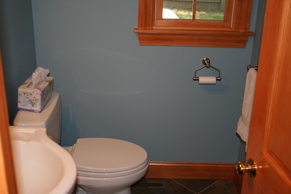 Small traditional 3/4 bathroom in Providence with furniture-like cabinets, dark wood cabinets, a two-piece toilet, a vessel sink, blue walls and porcelain floors.