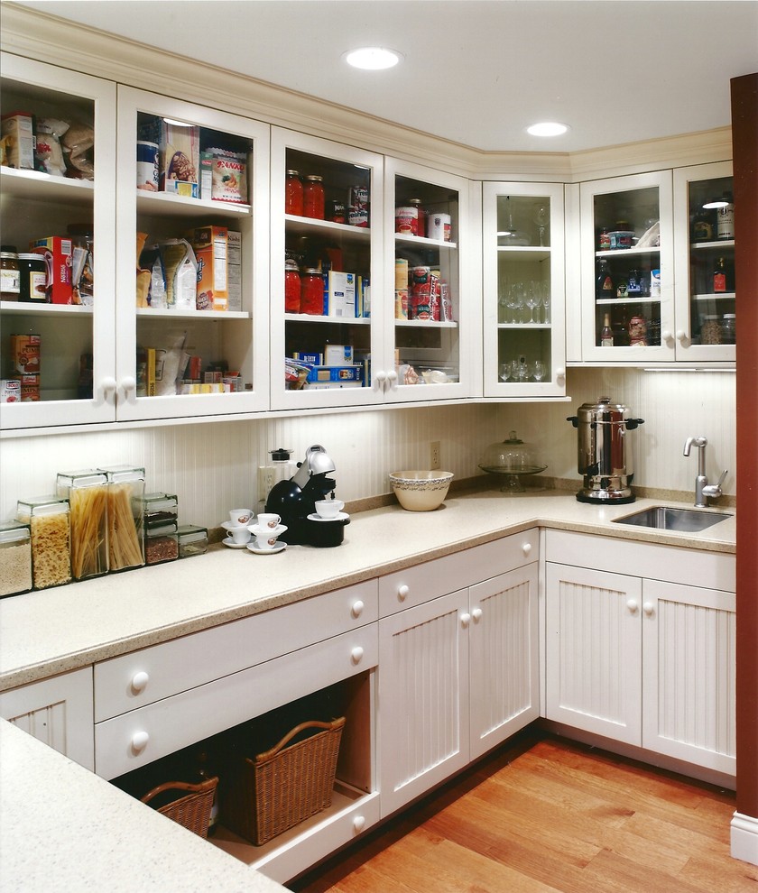 Inspiration for a traditional kitchen in Cincinnati with glass-front cabinets and white cabinets.