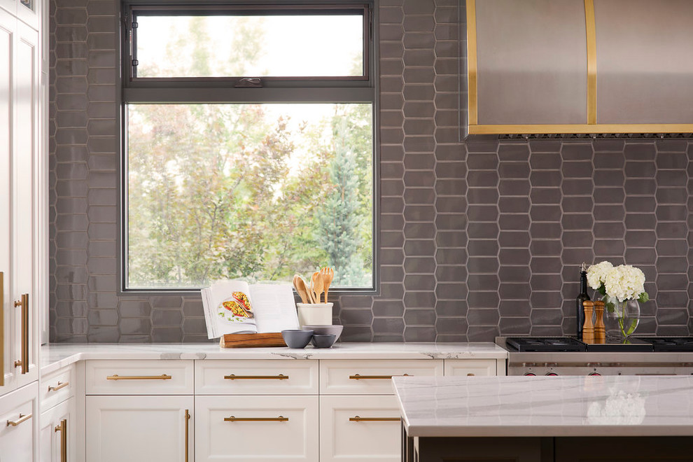 Inspiration for a large transitional single-wall light wood floor and brown floor open concept kitchen remodel in Calgary with an undermount sink, shaker cabinets, white cabinets, marble countertops, gray backsplash, ceramic backsplash, stainless steel appliances and an island