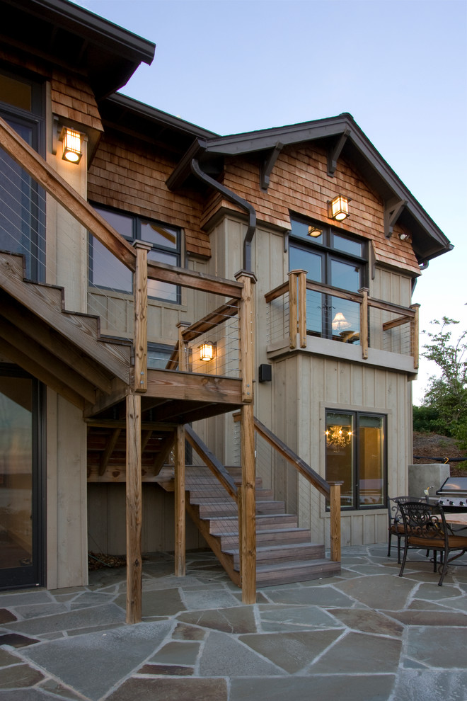 This is an example of a mid-sized country two-storey exterior in Other with wood siding.