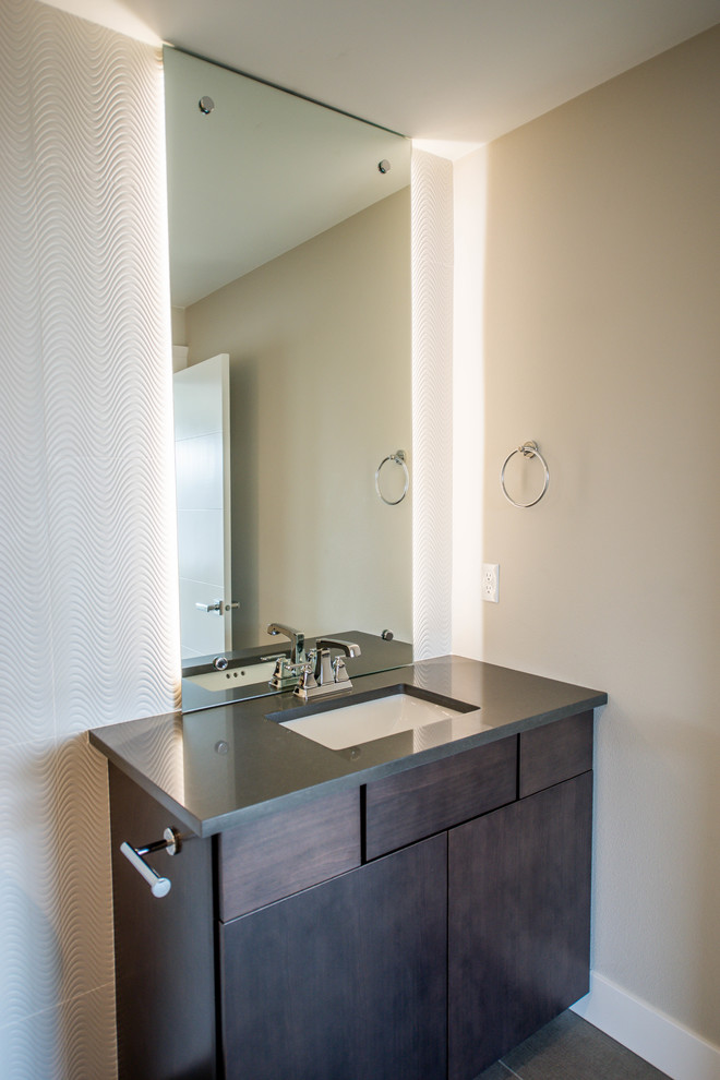 Photo of a mid-sized modern bathroom in Seattle with flat-panel cabinets, dark wood cabinets, an alcove tub, a shower/bathtub combo, a two-piece toilet, white tile, porcelain tile, grey walls, porcelain floors, an undermount sink, engineered quartz benchtops, grey floor, a shower curtain and grey benchtops.