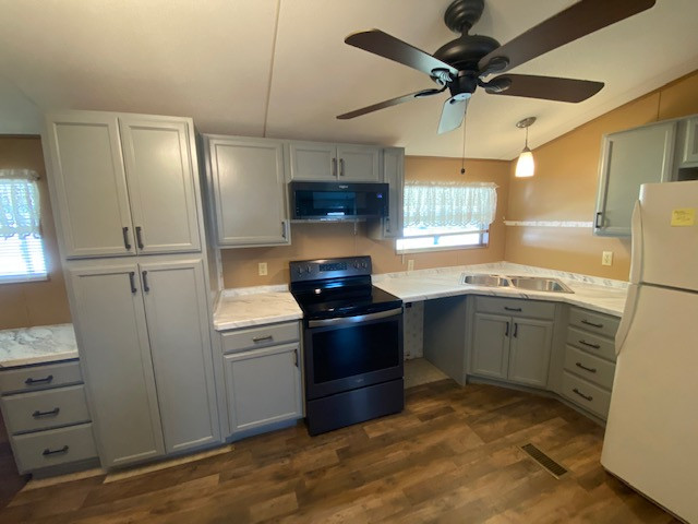 Example of a large l-shaped eat-in kitchen design with a drop-in sink, flat-panel cabinets, gray cabinets, laminate countertops, no island and white countertops