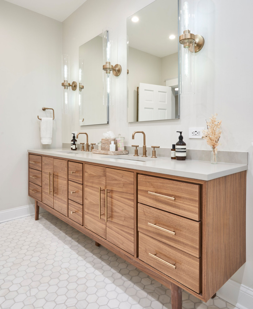 Inspiration for a mid-sized transitional master bathroom in Chicago with flat-panel cabinets, medium wood cabinets, a freestanding tub, an alcove shower, white tile, porcelain tile, white walls, porcelain floors, an undermount sink, quartzite benchtops, white floor, a hinged shower door, white benchtops, a shower seat, a double vanity and a freestanding vanity.