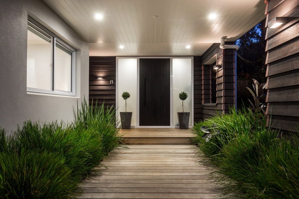 Design ideas for a mid-sized contemporary front door in Auckland with white walls, light hardwood floors, a single front door, a black front door and beige floor.