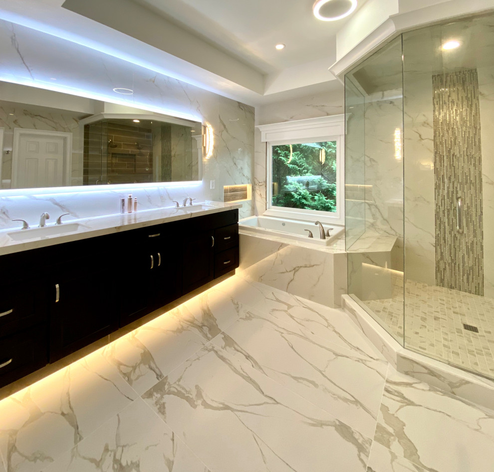 Large modern master bathroom in Atlanta with shaker cabinets, dark wood cabinets, a drop-in tub, a double shower, a one-piece toilet, porcelain tile, porcelain floors, an undermount sink, tile benchtops, a hinged shower door, an enclosed toilet, a double vanity, a built-in vanity and recessed.