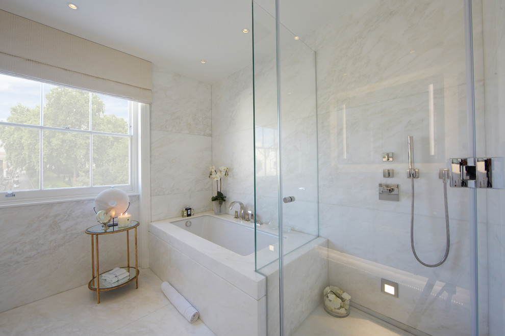 Design ideas for a medium sized contemporary bathroom in London with a built-in bath, a built-in shower, marble tiles, marble flooring and a hinged door.