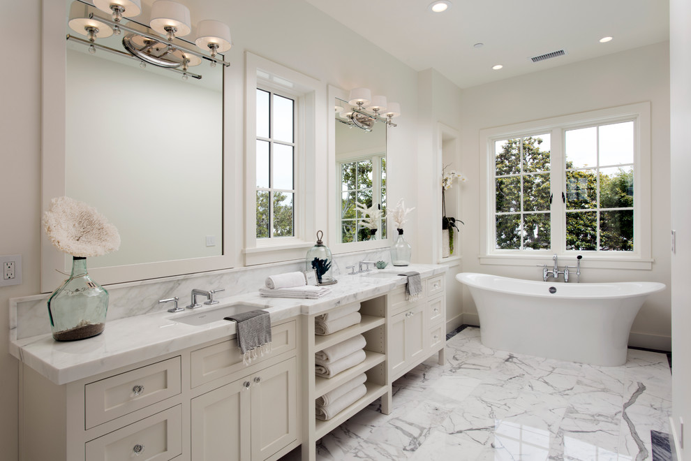 Inspiration for a large transitional master bathroom in Orange County with shaker cabinets, white cabinets, a freestanding tub, white walls, marble benchtops and an undermount sink.