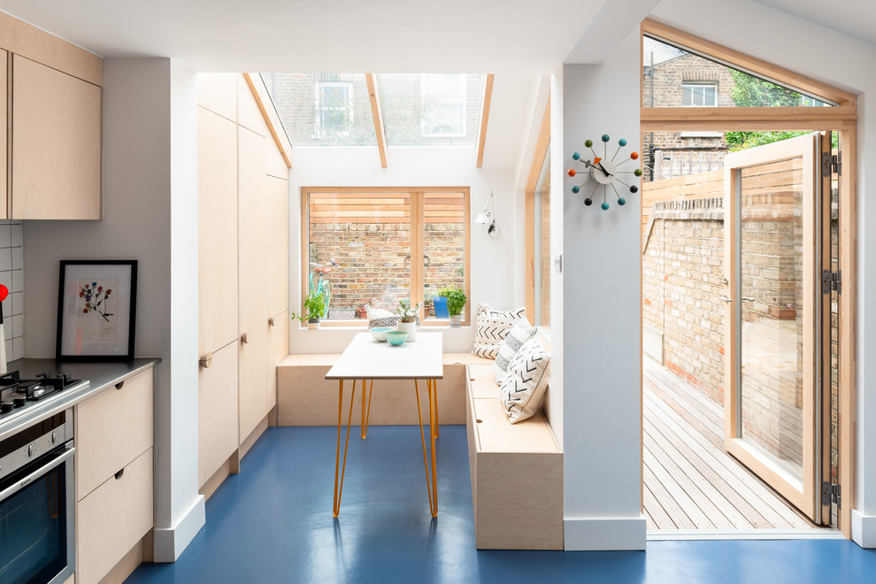 Medium sized scandinavian dining room in London with blue floors and white walls.
